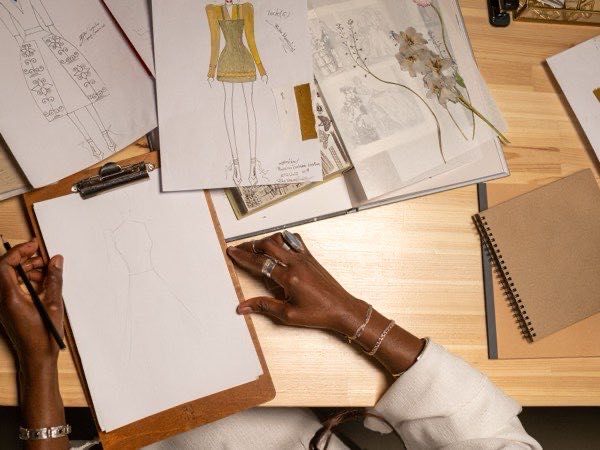 Apparel designer working on technical sketches and patterns
