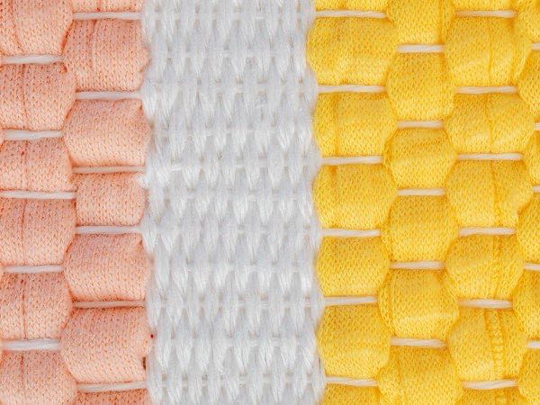 Rolls of knitted fabric in a range of colours and structures
