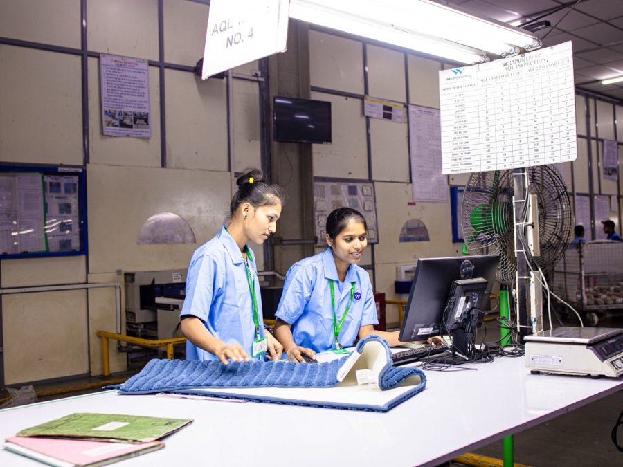 Quality inspectors checking garments against specification