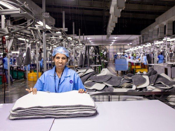 Garment factory operator at an industrial sewing station
