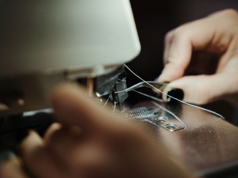Close-up of a garment being sewn on an industrial machine
