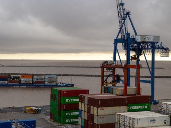 Shipping port with stacked cargo containers awaiting loading