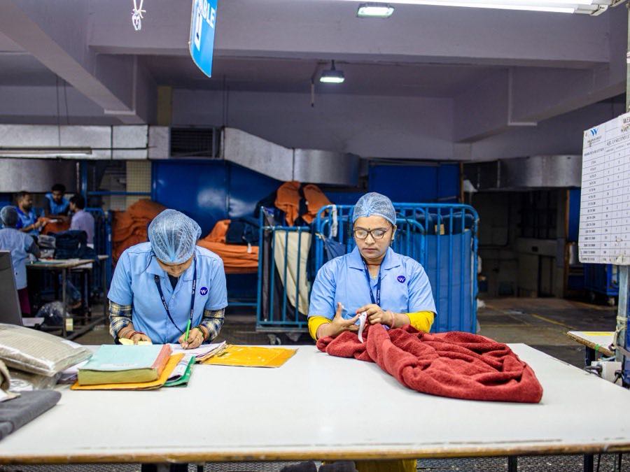 Factory workers sorting and bundling cut garment panels