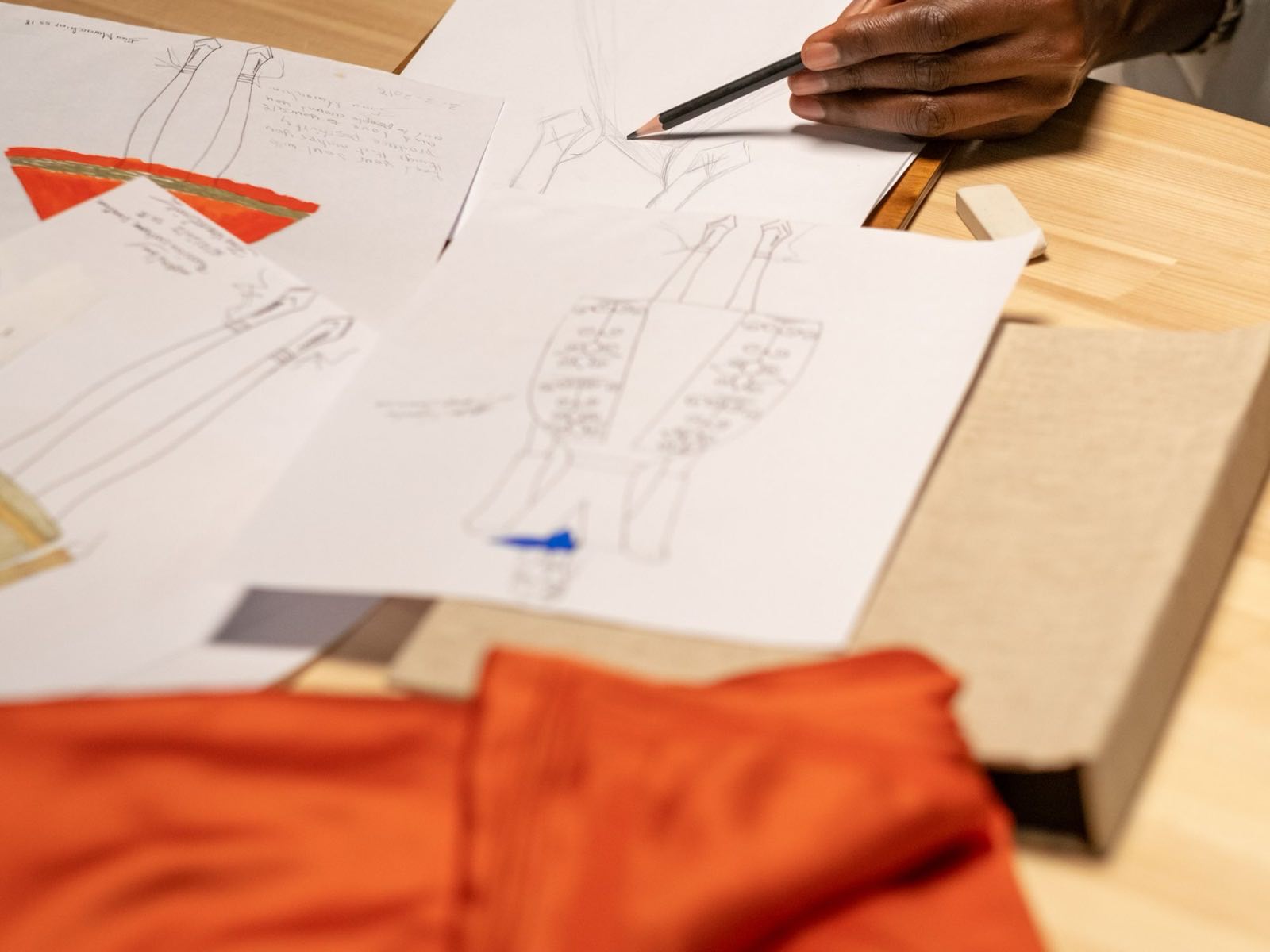 Technical sketches laid out with fabric swatches