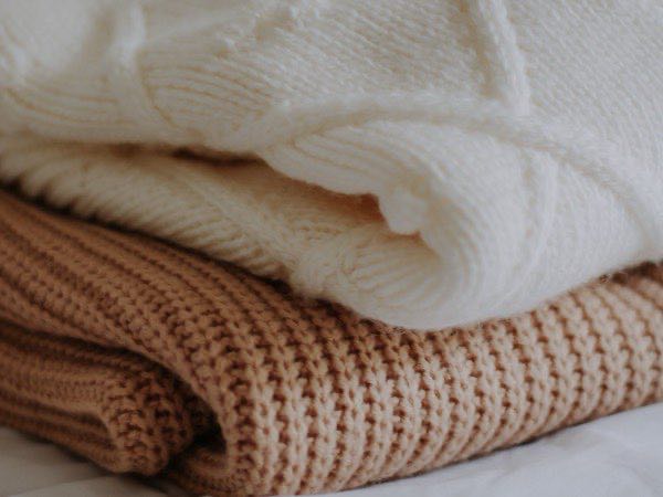 Folded knitted sweaters showing rib and waffle structures
