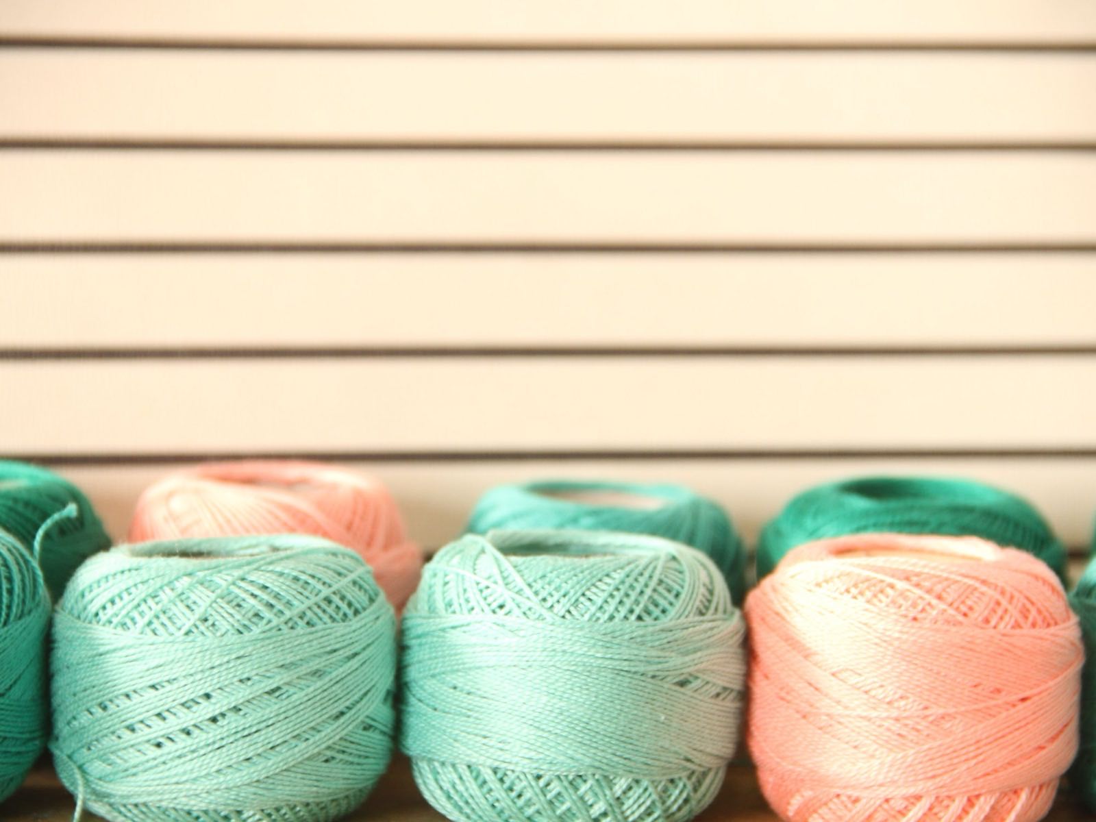 Cones of coloured yarn prepared for knitting